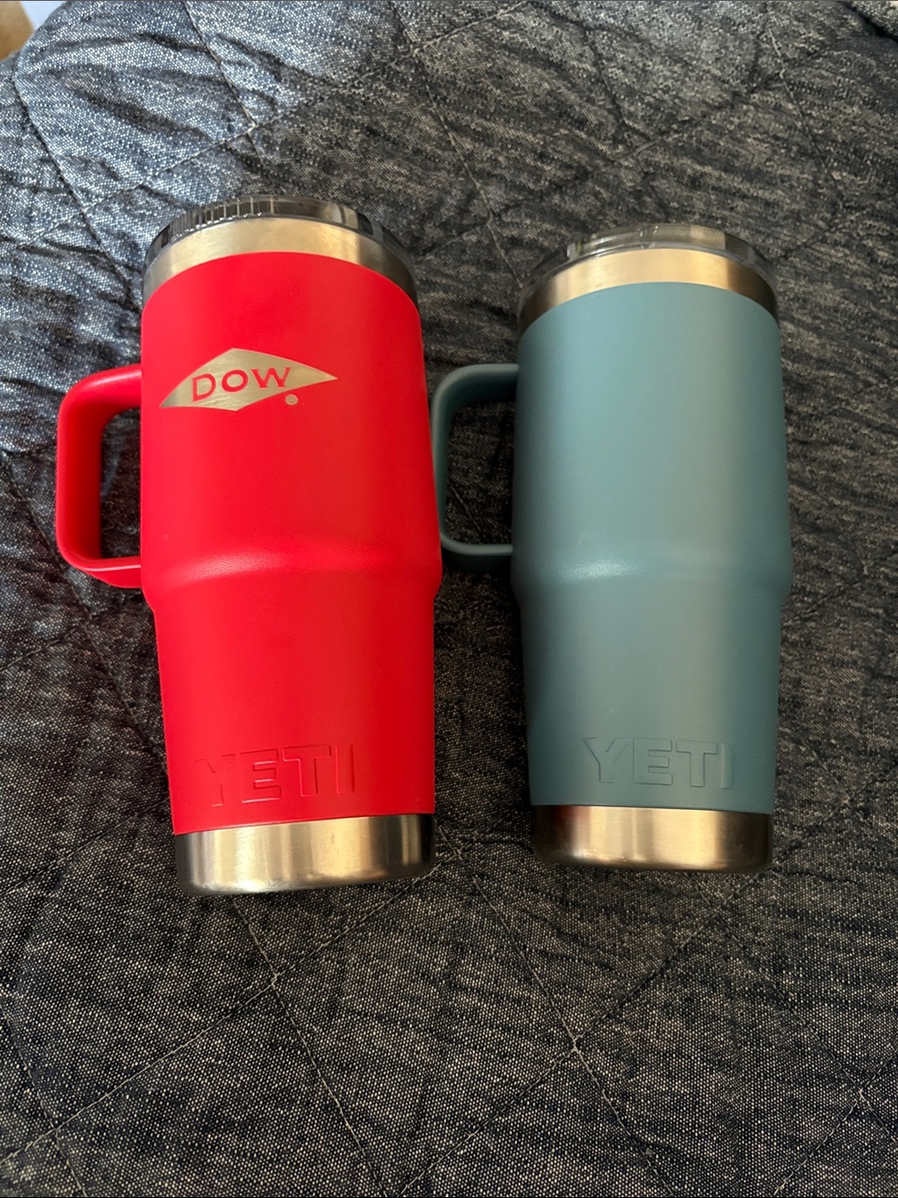 2 Yeti Rambler Mugs in Red and Teal one Dow logo